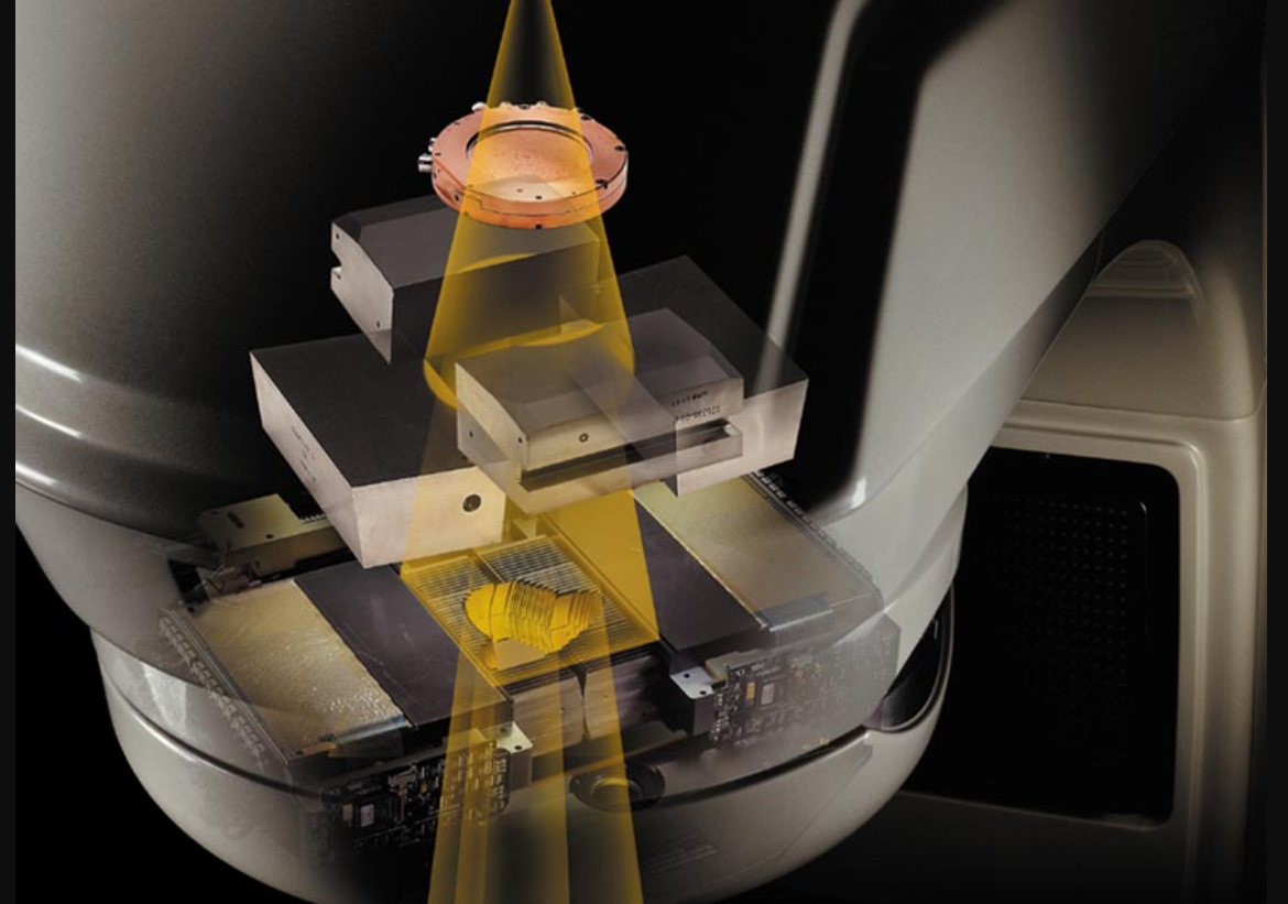 Medical CT scanner with rotating gantry and patient table, highlighting the X-ray beam path in yellow